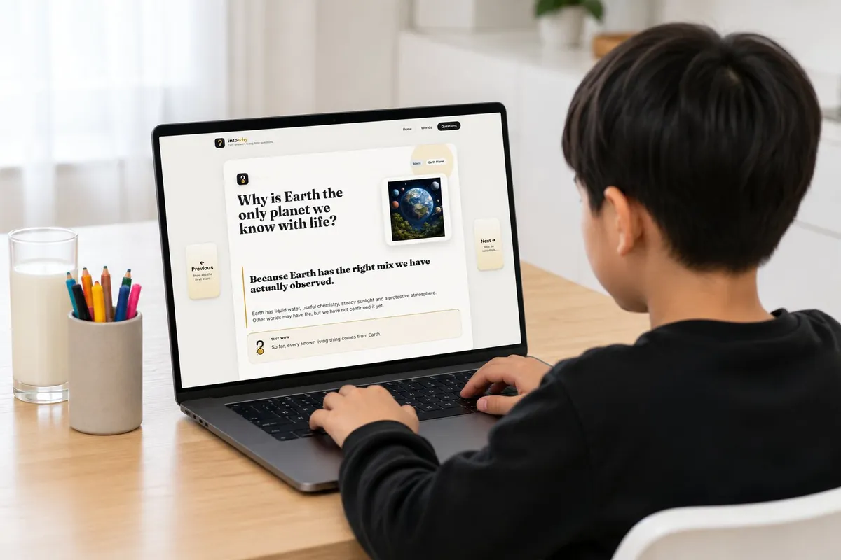 A child reading an IntoWhy question card on a laptop